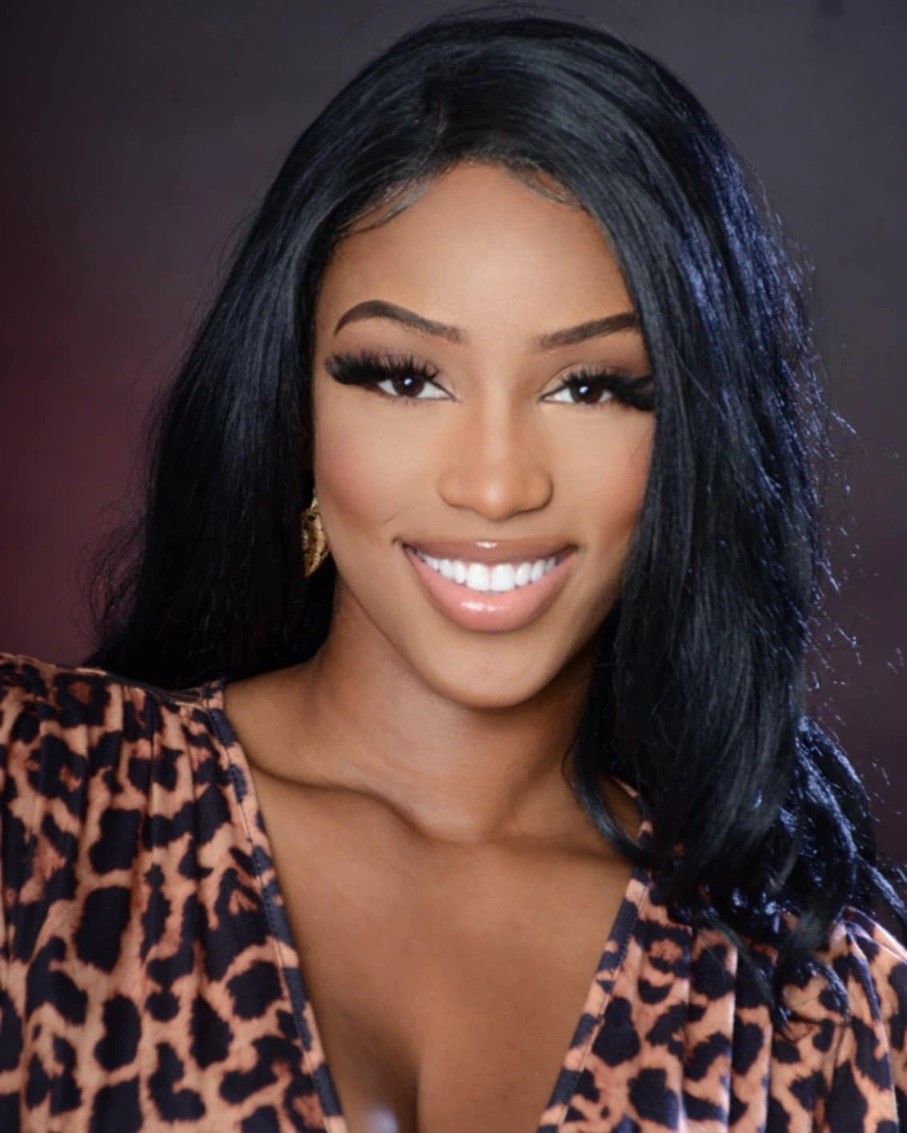 Shania Moore smiling in her artist headshot